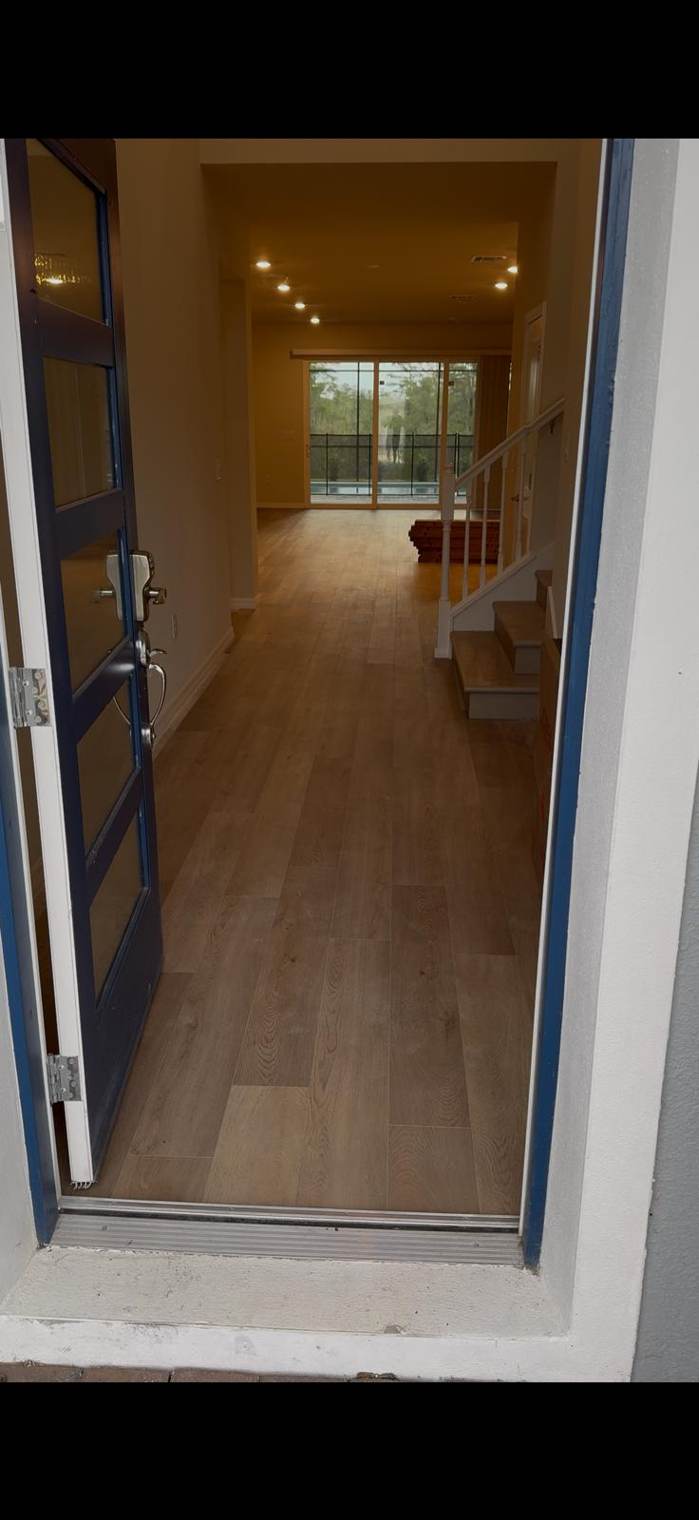 Plank floor running from the front door through the home